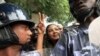 FILE - Lubna Hussein (C), a former journalist and U.N. press officer, gestures outside the court after her trial in Sudan's capital Khartoum, August 4, 2009.