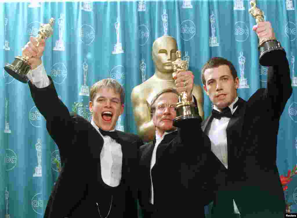 Oscar winners (L-R) Matt Damon, Robin Williams and Ben Affleck hold their Oscars for their work on the film &quot;Good Will Hunting&quot; at the 70th Annual Academy Awards, March 23, 1998, in Los Angeles. Damon and Affleck won for Best Screenplay Written Directly for the Screen and Williams won for Best Supporting Actor.