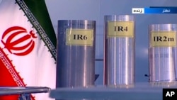 FILE - In this June 6, 2018 frame grab from the Islamic Republic Iran Broadcasting, IRIB, state-run TV, three versions of domestically-built centrifuges are shown in a live TV program from Natanz, an Iranian uranium enrichment plant, in Iran. 