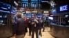 Traders work on the floor of the New York Stock Exchange in New York, March 18, 2014.