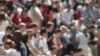FILE - Crowds of people