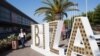 A tourist walks with her suitcase outside the airport in the Spanish island of Ibiza on July 30, 2020.