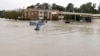  Jordan Bennett, of Rock Hill, S.C., paddles down a flooded a street in Columbia, S.C., Sunday, Oct. 4, 2015.