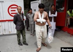 A man injured in a blast leaves a hospital after treatment in Kabul, Afghanistan, May 8, 2019.