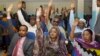 Somalia lawmakers raise their hands during a confidence vote on Prime Minister Abdiweli Sheikh Ahmed, at the Parliament Building in Mogadishu, Somalia, Dec. 6, 2014.