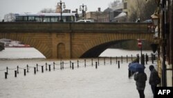  Pedestrians walk on the Ouse Bridge as the level of the River Ouse rises in York, North Yorkshire, Feb. 15, 2020, as Storm Dennis sweeps in. The country is bracing itself for widespread weather disruption for the second weekend in a row.