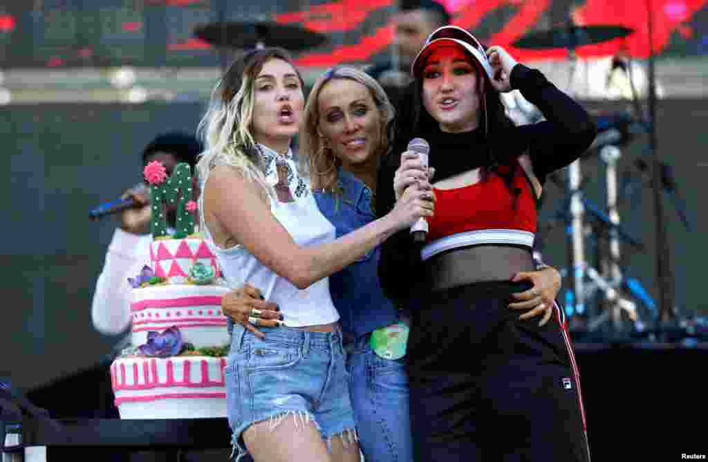 Miley (L) and Noah (R) Cyrus sing happy birthday to their mom Tish at the Wango Tango concert in Carson, California, May 13, 2017.