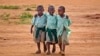 FILE - Young schoolboys walk home in the village of Nyumbani, Kenya, which caters to children who lost their parents to HIV, and grandparents who lost their children to HIV.