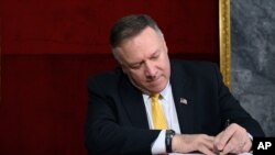 US Secretary of State Mike Pompeo signs the guest book at the Ministry of Foreign Affairs in Luanda, Angola, Monday Feb. 17, 2020. Pompeo started his tour of Africa in Senegal, the first U.S. Cabinet official to visit in more than 18 months. He left…