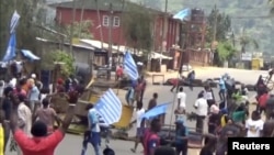FILE - A still image taken from a video shot on Oct. 1, 2017, shows protesters waving Ambazonian flags in front of road block in the English-speaking city of Bamenda, Cameroon. 
