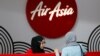 FILE - An AirAsia counter staff attends to a customer at Kuala Lumpur International Airport, Malaysia, Aug. 28, 2016. 