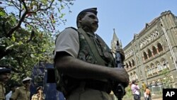 A policeman stands guard outside the Bombay High Court before the delivery of a judgement for Mohammad Ajmal Kasab, Mumbai, February 21, 2011