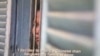 FILE - A Cambodian woman standing behind a window details her forced marriage experience in the 2015 film "Bride with a Price Tag," produced by USAID’s office to combat human trafficking.