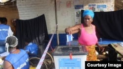FILE - A woman votes in Liberia's Special Senatorial election.