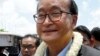 FILE - In this Aug. 16, 2015, file photo, Sam Rainsy, leader of the opposition Cambodia National Rescue Party, greets his party supporters upon his arrival at Phnom Penh International Airport in Phnom Penh, Cambodia. The Phnom Penh Municipal Court on Tuesday, Nov. 8, 2016, found Sam Rainsy, country's exiled opposition leader, guilty of defamation for alleging that a senior government official sought to inflate Prime Minister Hun Sen's online popularity by buying "likes" for his Facebook page. (AP Photo/Heng Sinith, File)