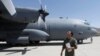 FILE - An Afghan Air Force pilot checks a C-130 military transport plane before a flight in Kabul, Afghanistan, July 9, 2017. 