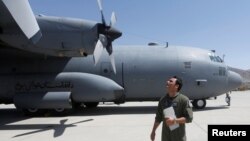 FILE - An Afghan Air Force pilot checks a C-130 military transport plane before a flight in Kabul, Afghanistan, July 9, 2017. 