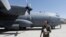 FILE - An Afghan Air Force pilot checks a C-130 military transport plane before a flight in Kabul, Afghanistan, July 9, 2017. 