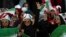 An Iranian woman flashes a victory sign during a soccer match between Iran and Cambodia in the 2022 World Cup qualifier at the Azadi (Freedom) Stadium in Tehran, Iran, Oct. 10, 2019. Iranian women were allowed into the stadium for the first time in years.