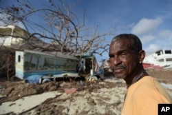 Juan Antonio Higuey shows his destroyed home at Cold Bay community after the passage of Hurricane Irma, in St. Martin, Sept. 11, 2017.