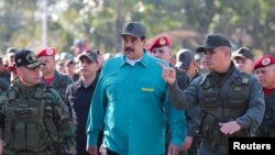 Venezuelan President Nicolas Maduro speaks with senior military officials during a military exercise in Valencia, Venezuela, Jan. 27, 2019.
