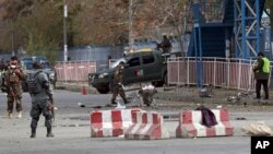 Security forces inspect the site of a deadly blast in the center of Kabul, Afghanistan, Nov. 12, 2018.
