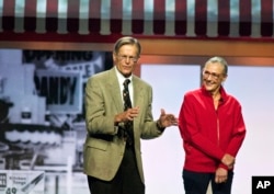 Jim Walton and Alice Walton speak during the Walmart shareholders' meeting in Fayetteville, Arkansas., June 1, 2012.