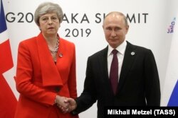 JAPAN -- British Prime Minister Theresa May and Russian President Vladimir Putin meet on the sidelines of the G20 summit in Osaka, June 28, 2019