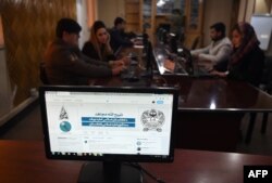 FILE -The Twitter page of Taliban spokesman Zabihullah Mujahid is pictured on a computer monitor in the newsroom at Maiwand TV station in Kabul, Feb. 6, 2019.