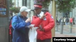 City ambassador Wayne Alexis helps a tourist find his way in San Francsico, California. (Photo courtesy Union Square BID)