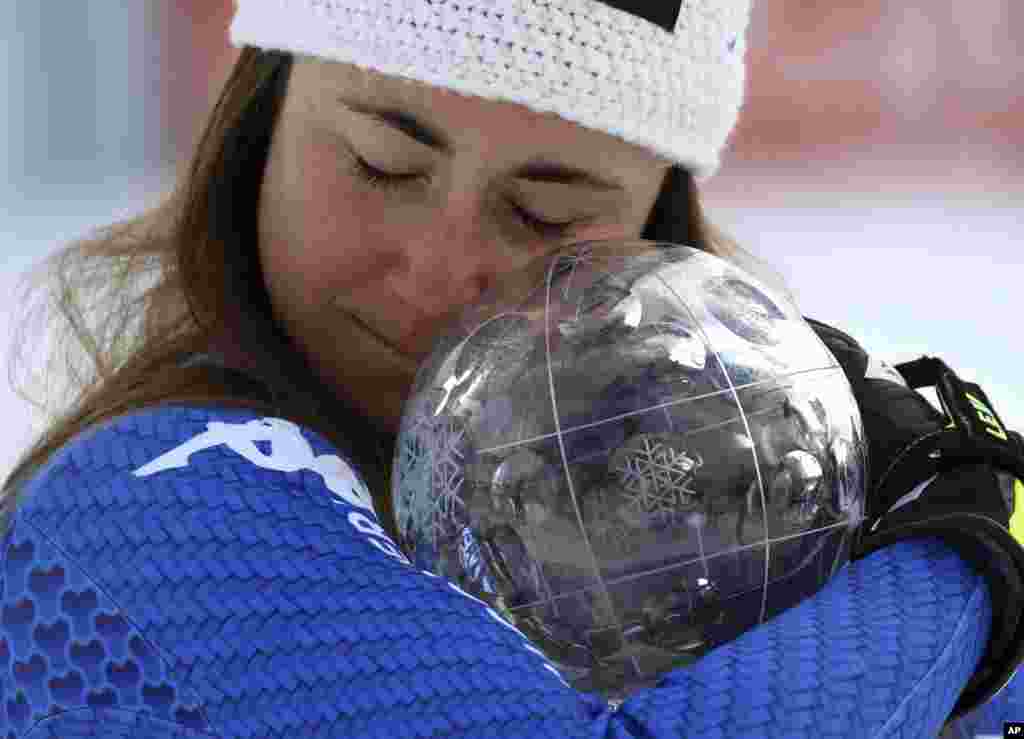 Italy&#39;s Sofia Goggia holds the women&#39;s World Cup downhill discipline trophy, at the alpine ski World Cup finals in Are, Sweden.