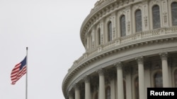 FILE-The U.S. Capitol during a morning rainstorm, after Congress agreed to a multi-trillion dollar economic stimulus package created in response to the economic fallout from the COVID-19 Coronavirus, on Capitol Hill in Washington, March 25, 2020.