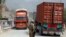 FILE - U.S. soldier watches trucks crossing Torkham gate border between Afghanistan and Pakistan in Nangarhar province, Afghanistan.