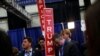 A campaign staffer holds a sign near where Republican U.S. presidential nominee Donald Trump (not pictured) talks to reporters in the spin room after his first debate against Democratic U.S. presidential nominee Hillary Clinton at Hofstra University in He