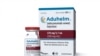 This image provided by Biogen, June 7, 2021 shows a vial and packaging for the drug Aduhelm.