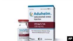 This image provided by Biogen, June 7, 2021 shows a vial and packaging for the drug Aduhelm.