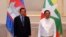 Cambodian Prime Minister Hun Sen, left, poses for photographs together with Myanmar State Administration Council Chairman, Senior General Min Aung Hlaing, right, before holding a meeting in Naypyitaw, Myanmar, Friday, Jan. 7, 2022. 
