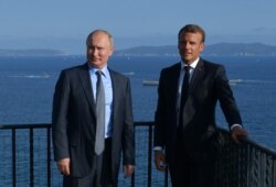FILE - Russian President Vladimir Putin meets with French President Emmanuel Macron at Fort Bregancon near the village of Bormes-les-Mimosas, France, Aug. 19, 2019.