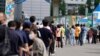 People wait for coronavirus testing at a testing site in Seoul, South Korea, July 7, 2021.