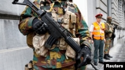 A Belgian soldier stands guard outside the prime minister's office building during a meeting of the government's security council in Brussels, June 18, 2016.