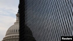 The U.S. Capitol dome is seen behind a security fence in Washington, Jan. 11, 2021. 