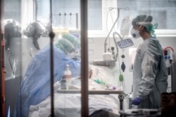 Medical personnel at work in the intensive care unit of the hospital of Brescia, Italy, March 19, 2020.