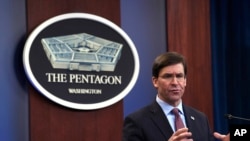 FILE - Defense Secretary Mark Esper speaks at the Pentagon in Washington, Dec. 20, 2019. After the Pensacola shooting, Esper ordered a review of the Pentagon's handling of foreign military students.