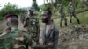 Congolese M23 rebel fighters detain a man near Kibumba, north of Goma Nov. 27, 2012.