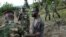 Congolese M23 rebel fighters detain a man near Kibumba, north of Goma Nov. 27, 2012.