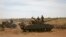 Somalia Al-Shabab's Resurgence: FILE - In this Wednesday, Feb. 29, 2012 file photo, Ethiopian military tanks sit in position on the outskirts of the town of Baidoa in Somalia. 