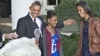 President Barack Obama, with daughters Sasha (l) and Malia carries on the Thanksgiving tradition of saving a turkey from the dinner table with a "presidential pardon," Nov. 21, 2012, in the Rose Garden of the White House.