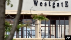 A Kenyan soldier runs through a corridor on an upper floor, shortly before an explosion was heard, at the Westgate Mall in Nairobi, Kenya, Sept. 24, 2013. 