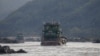 FILE - Chinese cargo ships sail on the Mekong River near the Golden Triangle at the border between Laos, Myanmar and Thailand, March 1, 2016.