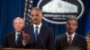 IRS Commissioner John Koskinen, left, and Deputy Attorney General James Cole, right, watch as Attorney General Eric Holder speaks during a news conference at the Justice Department, on Monday, May 19, 2014.